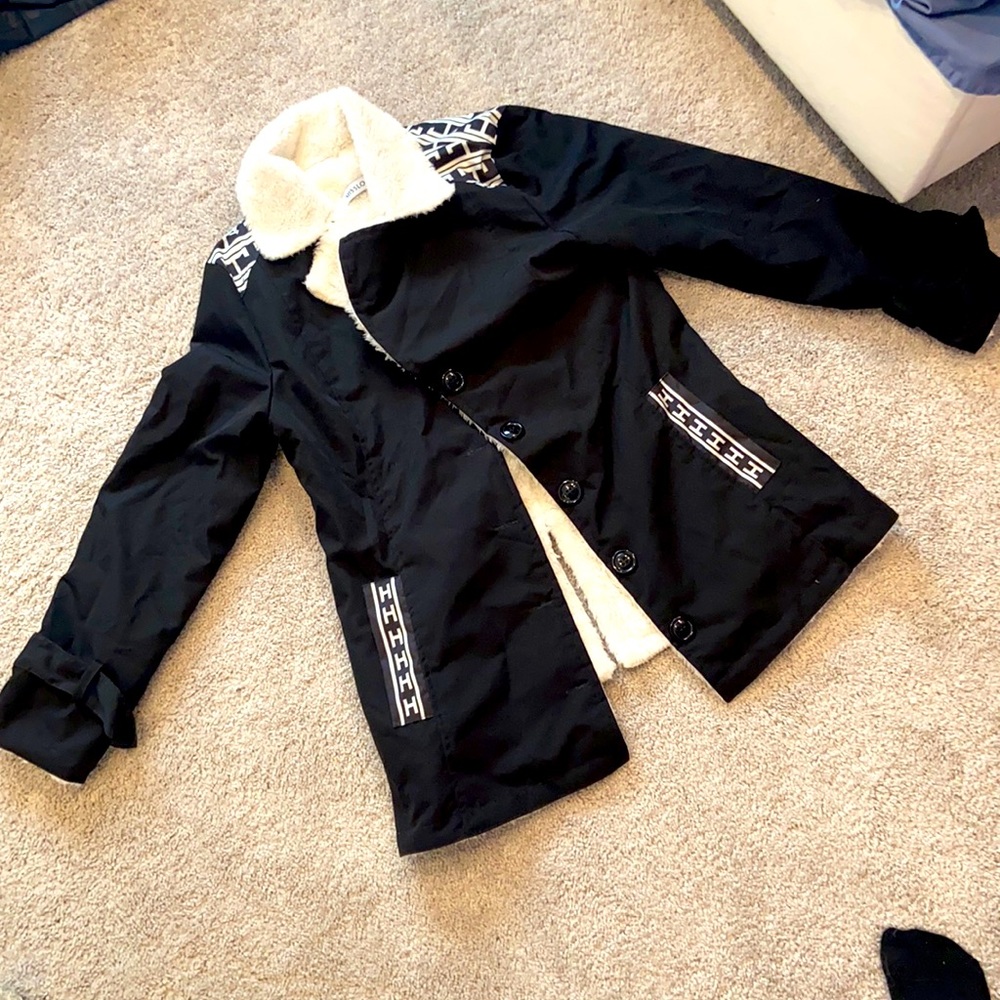 Fuzzy, warm black jacket with buttons and collar.